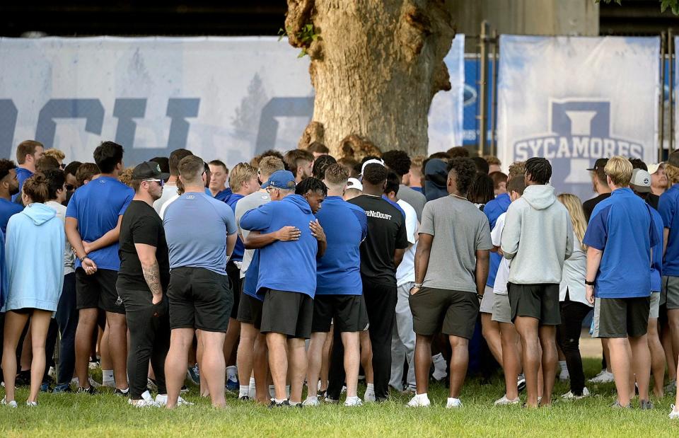 Indiana State football assistant head coach Mark Smith hugs a player after a vigil Sunday night in Terre Haute, Indiana, for students, including fellow football players, who were involved in a car crash earlier in the day.