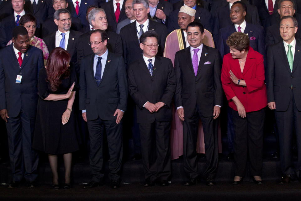 Argentina's President Cristina Fernandez, second from left, waves to Brazil's President Dilma Rousseff, second from right, during the group photo at the United Nations Conference on Sustainable Development, or Rio+20, in Rio de Janeiro, Brazil, Wednesday, June 20, 2012. Also in the picture are France's President Francois Hollande, front row third from left, and United Nations Secretary General Ban Ki-Moon, front row right. (AP Photo/Victor R. Caivano)