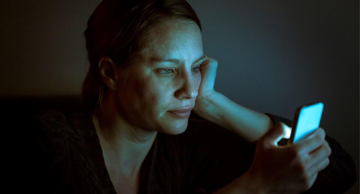 woman on phone late at nigh to represent Screen addiction mental health. (Getty Images)