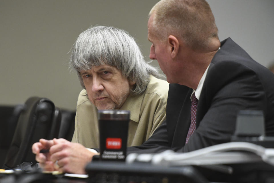 David Turpin, left, listens to his attorney during a sentencing hearing Friday, April 19, 2019, in Riverside, Calif. Turpin and his wife, Louise, who pleaded guilty to years of torture and abuse of 12 of their 13 children have been sentenced to life in prison with possibility of parole after 25 years. (Will Lester/The Orange County Register via AP, Pool)