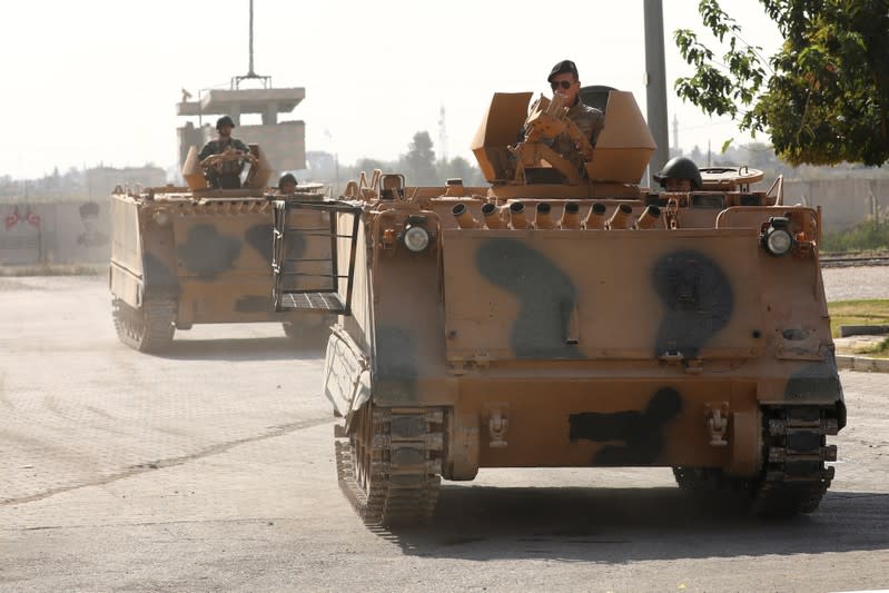 Turkish soldiers in armored vehicles return from the Syrian town of Tal Abyad, as they are pictured on the Turkish-Syrian border in Akcakale