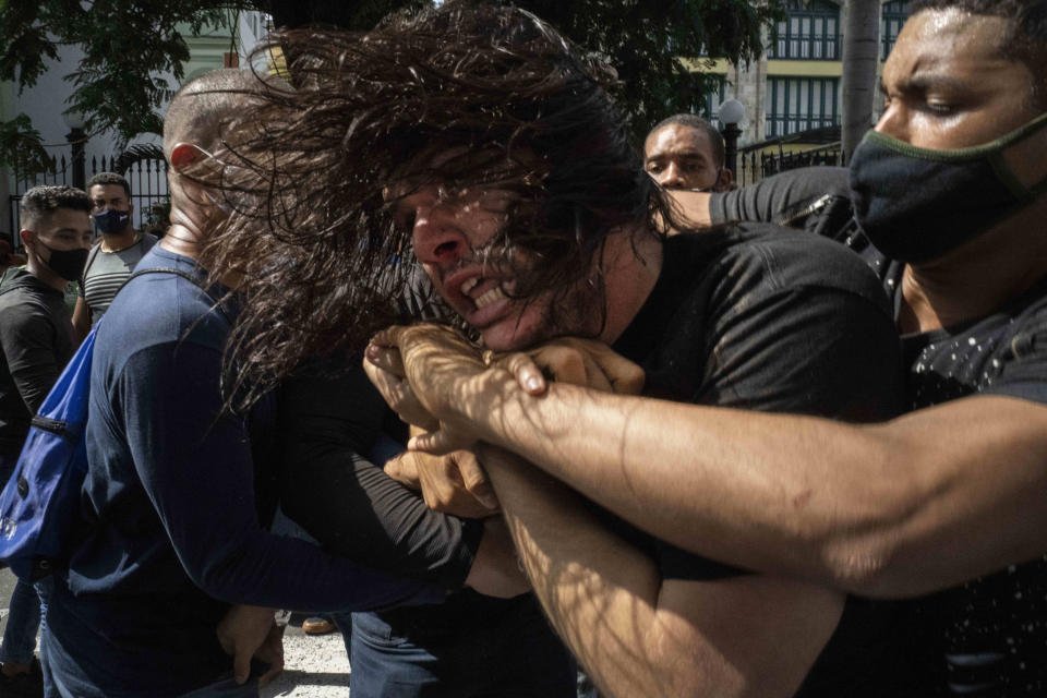 Image: plainclothes police detain an anti-government protester during a demonstration over high prices, food shortages and power outages, while some people also called for a change in the government, in Havana on July 11, 2021. (Ramon Espinosa / AP file)