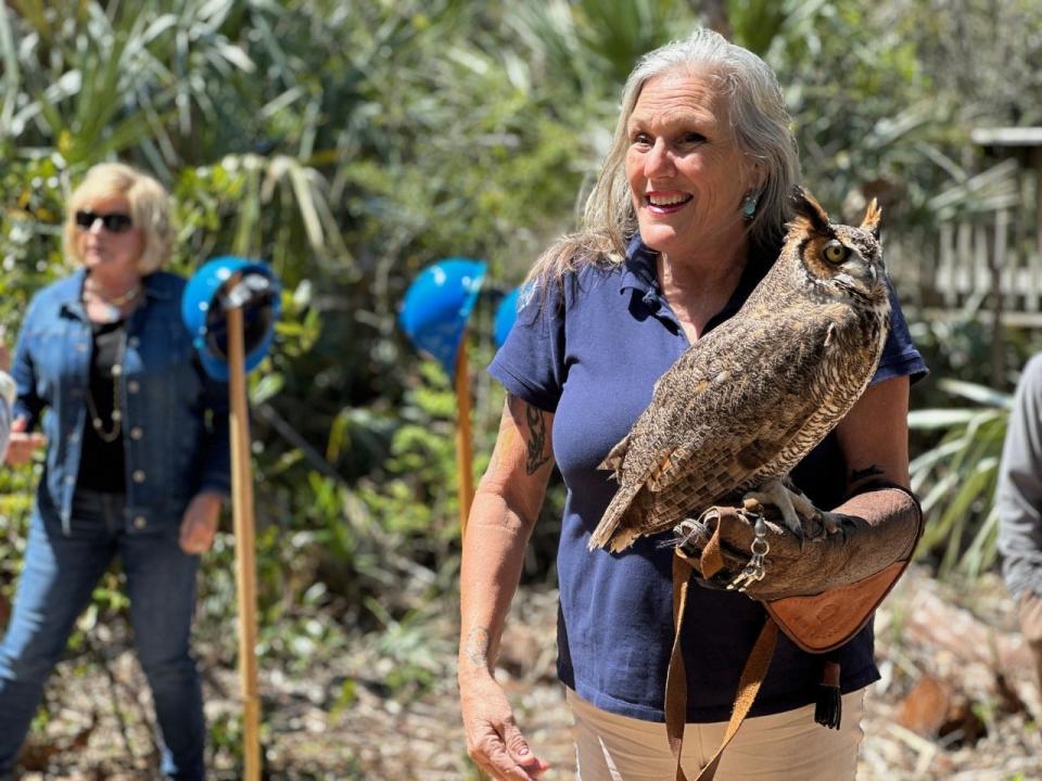 Shell Webster, the Marine Science Center's education programs manager, holds Bubba, a great-horned owl and one of the center's raptor ambassadors, Monday, March 20, 2023.