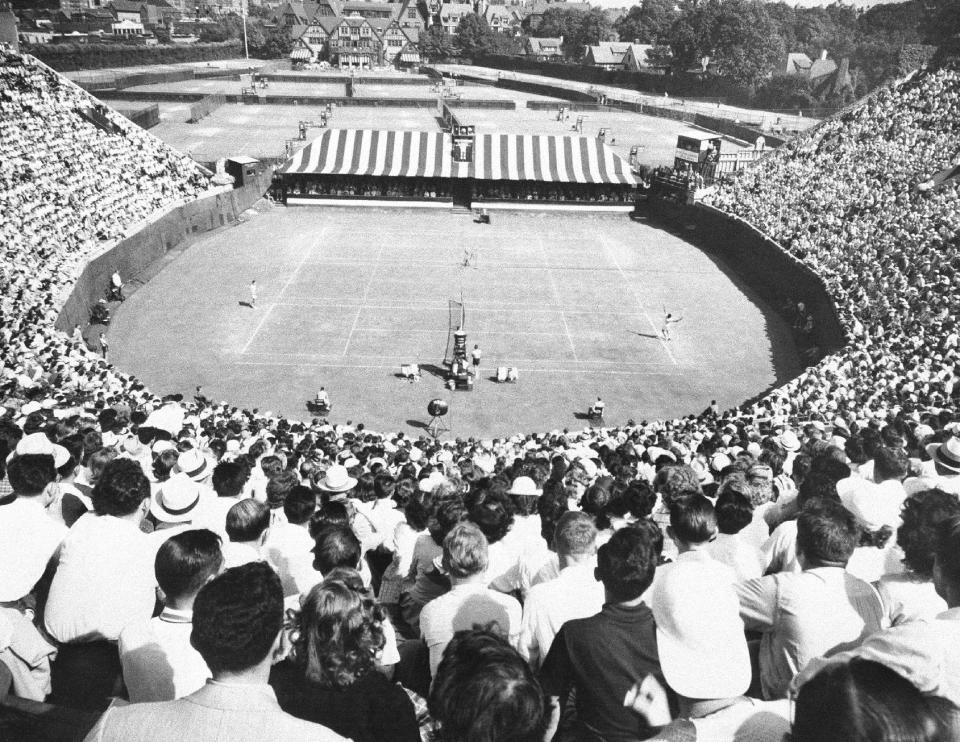 FILE - In this 1949 file photo, a championship match is played in the horseshoe stadium of the West Side Tennis Club in the Forest Hills neighborhood of the Queens borough of New York. The stadium that was one of the cathedrals of tennis and hosted US Open tennis for six decades; as well music greats; is planning to revive the sound of music at the 16,000-seat stadium and perhaps, one day, bring back big-time professional tennis. (AP Photo, File)