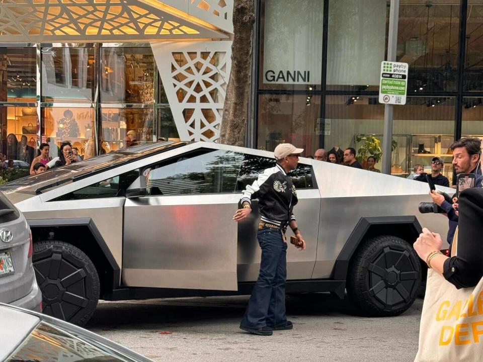 Pharrell exiting a Cybertruck