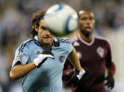KANSAS CITY, KS - NOVEMBER 02: Graham Zusi #8 of Sporting Kansas City chases a ball as Miguel Comminges #32 of the Colorado Rapids looks on during the MLS playoff game on November 2, 2011 at LiveStrong Sporting Park in Kansas City, Kansas. (Photo by Jamie Squire/Getty Images)