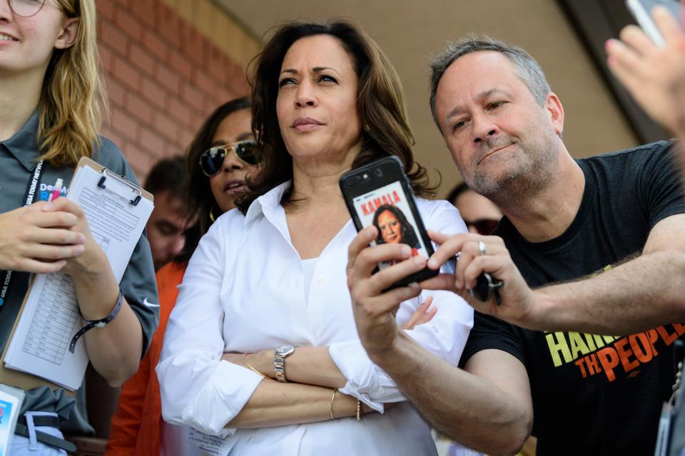 U.S. Sen. Kamala Harris, D-Cali., center, a 2020 democratic presidential candidate, listens to her introduction before walking onto the Des Moines Register Political Soapbox to give a stump speech to a packed crowd at the Iowa State Fair in Des Moines, Iowa, Saturday, Aug. 10, 2019. 