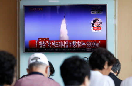 People watch a TV broadcast of a news report on North Korea's ballistic missile test, at a railway station in Seoul, South Korea, July 4, 2017. REUTERS/Kim Hong-Ji