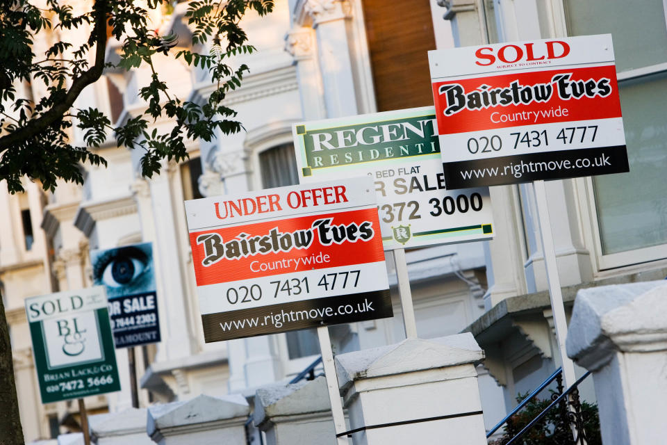 For sale signs in front of homes