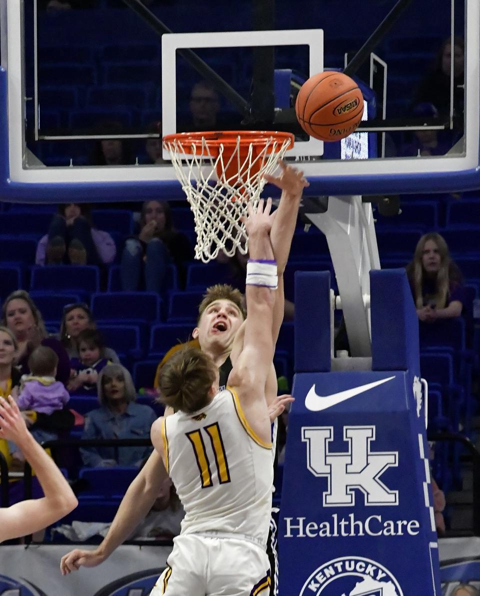 Covington Catholic's Mitchell Rylee, back, blocks a Lyon County shot in the lane at the KHSAA Sweet 16 Quarterfinals at Rupp Arena, March 18, 2022.