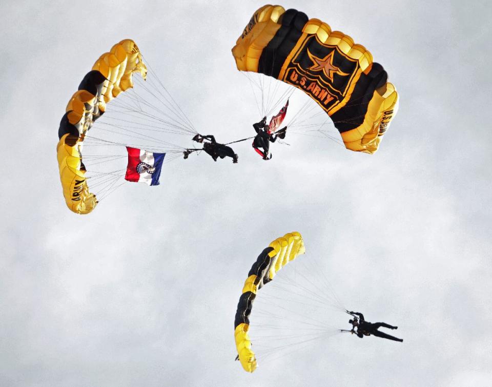 FILE - In this Tuesday, July 3, 2012 file photo, the U.S. Army Golden Knights parachute in before a baseball game between the St. Louis Cardinals and the Colorado Rockies, in St. Louis. The Golden Knights, along with theU.S Navy's Blue Angels and the U.S. Air Force's Thunderbirds, have cancelled their 2013 seasons because of the automatic federal budget cuts causing about 60 cancellations thus far and affecting more than 200 of the approximately 300 air shows held each year. (AP Photo/Tom Gannam, File)