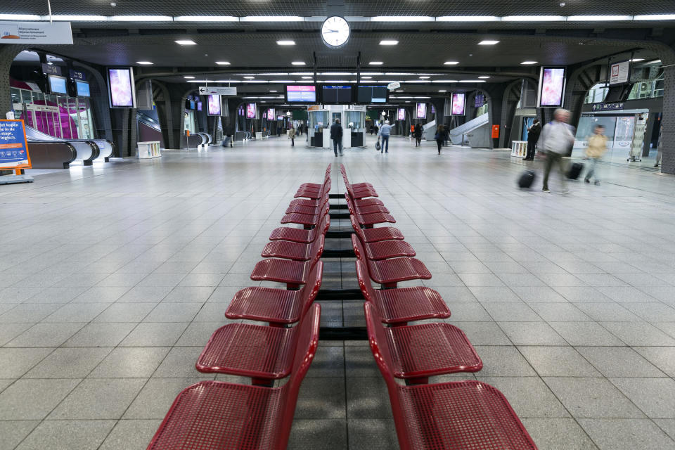 FILE -Passengers walk through a quiet Brussels Midi Station during a train strike on Wednesday, April 22, 2015. Belgium acknowledges that its major rail gateway has become a festering sore of drug abuse, poverty and violence. The Brussels Midi Station is a major stain on a nation preparing to take on the presidency of the European Union next year. (AP Photo/Thierry Monasse, File)