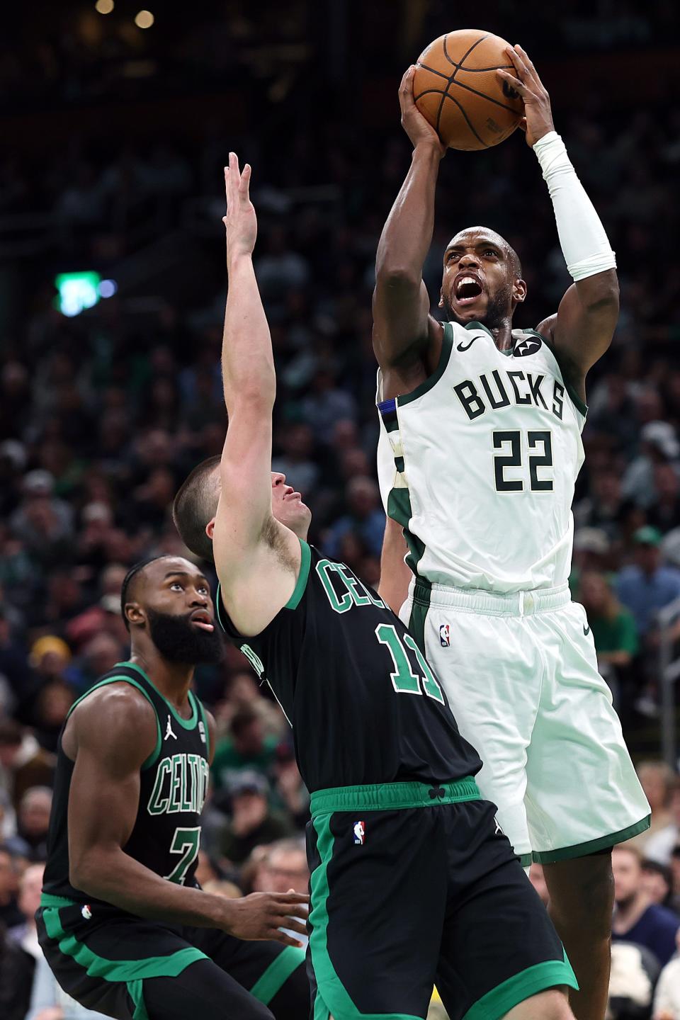 Khris Middleton of the Milwaukee Bucks takes a shot over Payton Pritchard of the Celtics on Nov. 22 in Boston.