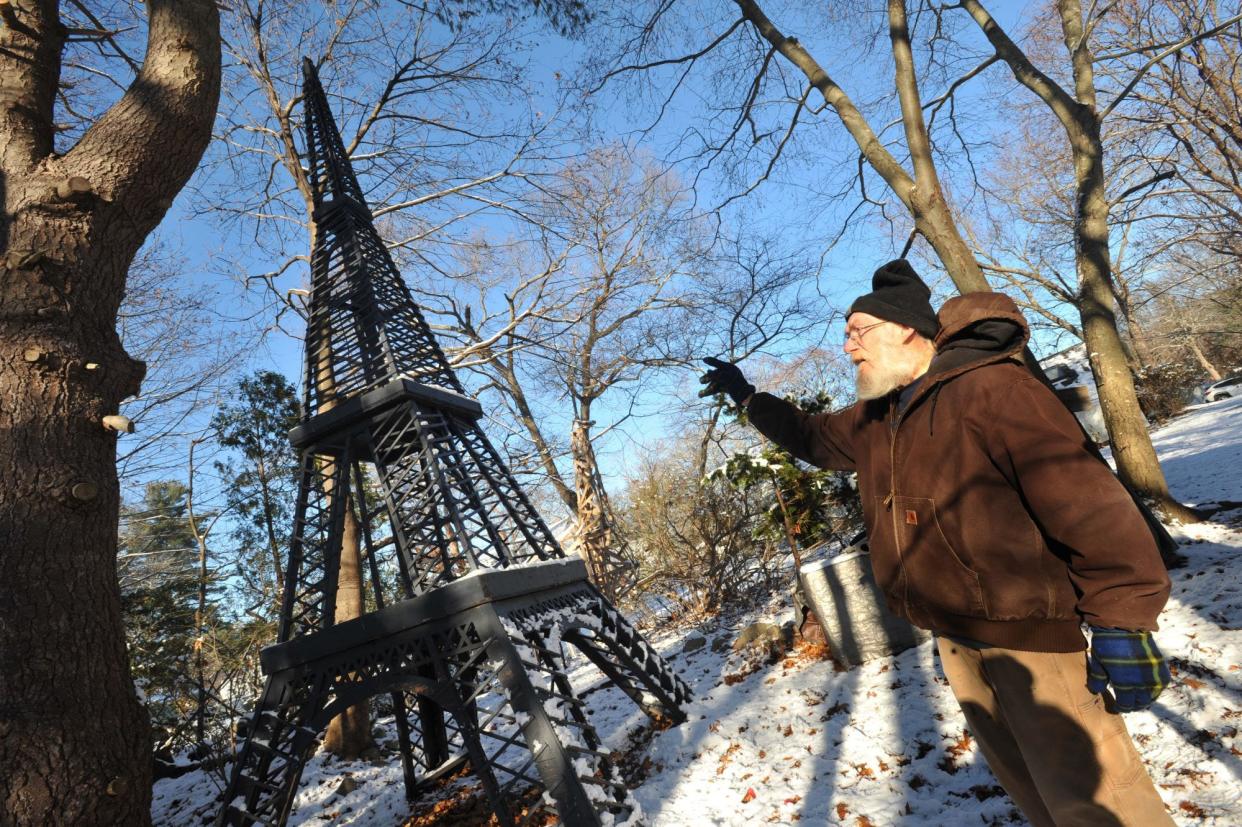 Steve Temple explains how he built this model of the Eiffel Tower in his Abington backyard in front of which Belmiro Da Veiga, of Brockton, proposed to his girlfriend, Amber Jogie, of Boston.