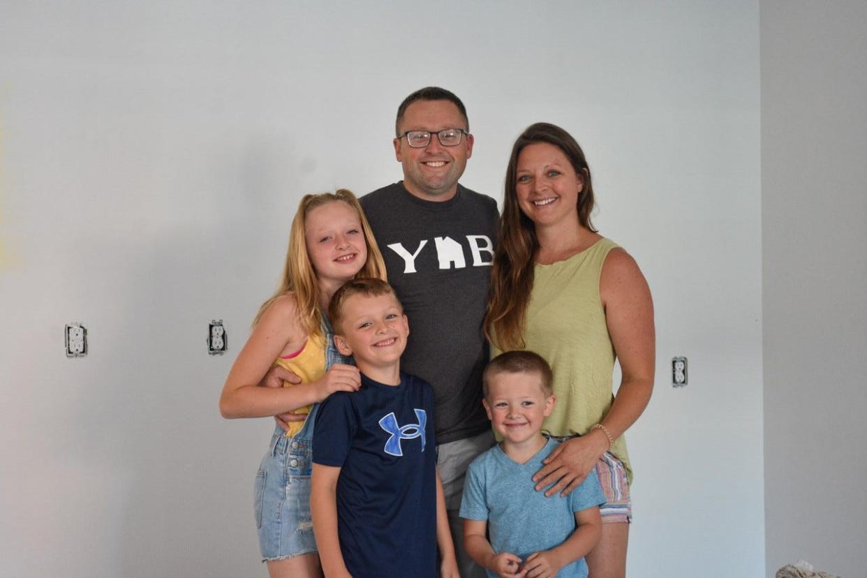 Drew and Jen Gatliff stand with their children, left to right, Asa, Hayden and Oakley, inside the yet-to-be-finished Yellow House Bakery. The Gatliffs have launched a crowdsourcing campaign to help fund the last stretch of the construction project.