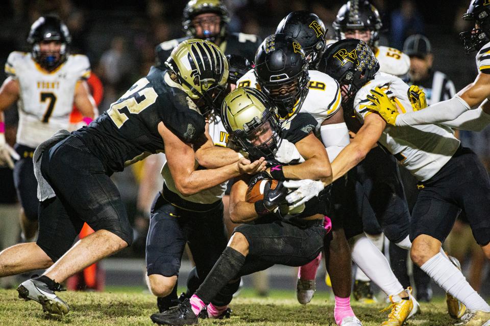 Oscar Martinez of the Gateway football team is swarmed by the Bishop Verot defense during a game at Gateway on Thursday, Oct. 12, 2023. Bishop Verot won 57-0.
