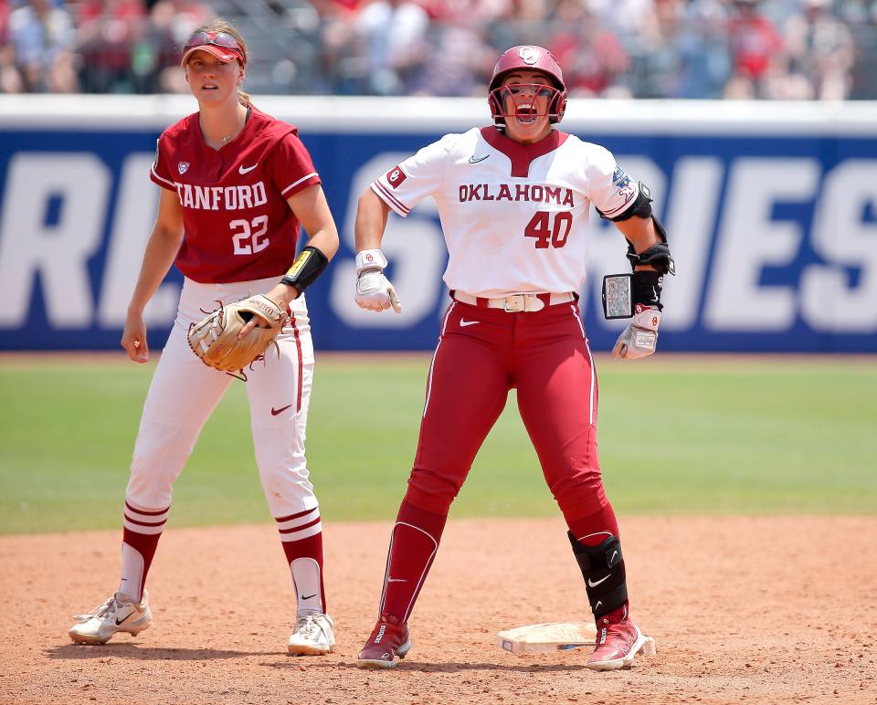Oklahoma's Alynah Torres (40) celebrates a double next to Stanford's River Mahler (22) during a softball game between the Oklahoma Sooners and Stanford in the Women's College World Series at USA Softball Hall of Fame Stadium in  in Oklahoma City, Monday, June, 5, 2023. 