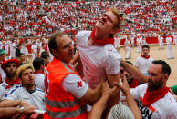 <p>A reveller injured by a wild cow is taken away from the bullring following the seventh running of the bulls at the San Fermin festival in Pamplona, northern Spain, July 13, 2017. (Photo: Susana Vera/Reuters) </p>