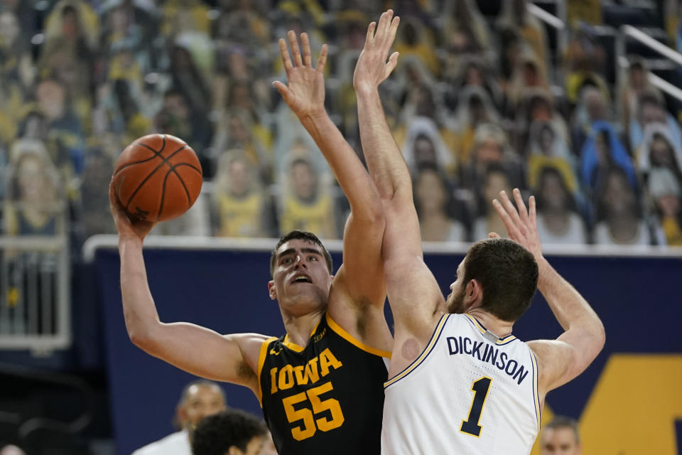 Iowa center Luka Garza (55) is defended by Michigan center Hunter Dickinson (1) during the first half of an NCAA college basketball game, Thursday, Feb. 25, 2021, in Ann Arbor, Mich. (AP Photo/Carlos Osorio)