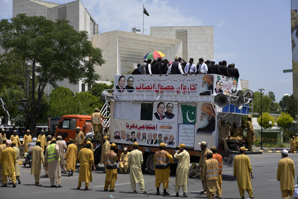 Supporters of Pakistan Democratic Movement, an alliance of the ruling political parties, take part in a rally outside the Supreme Court in Islamabad, Pakistan, Monday, May 15, 2023. Convoys of buses and vehicles filled with Pakistani pro-government supporters are flooding the main road leading to the country's capital on Monday to protest the release of former Prime Minister Imran Khan. (AP Photo/Anjum Naveed)