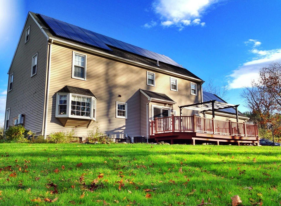 This undated publicity photo released by SolarCity shows Ben Kunz' house with solar panels installed on the roof in Cheshire, Conn. Kunz wanted to do “the green thing” and save on his electric bill without paying a lot of money up front. So instead of purchasing a solar system for his house, he leased one. (AP Photo/SolarCity)