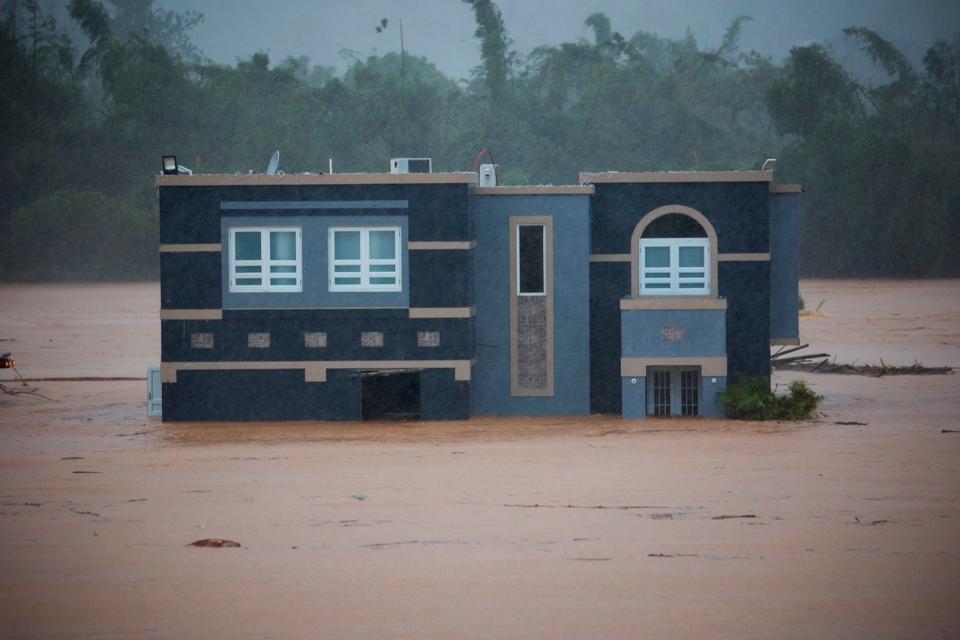 A home is submerged in floodwaters caused by Hurricane Fiona in Cayey, Puerto Rico, Sunday, 18 September 2022 (AP)