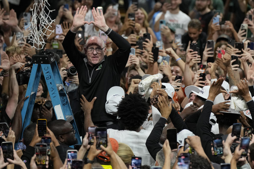 Miami coach Jim Larrañaga makes a letter "u" with his hands, for University of Miami, after Miami defeated Pittsburgh in an NCAA college basketball game to win a share of the Atlantic Coast Conference regular-season championship, Saturday, March 4, 2023, in Coral Gables, Fla. Miami shares the title with Virginia. (AP Photo/Rebecca Blackwell)