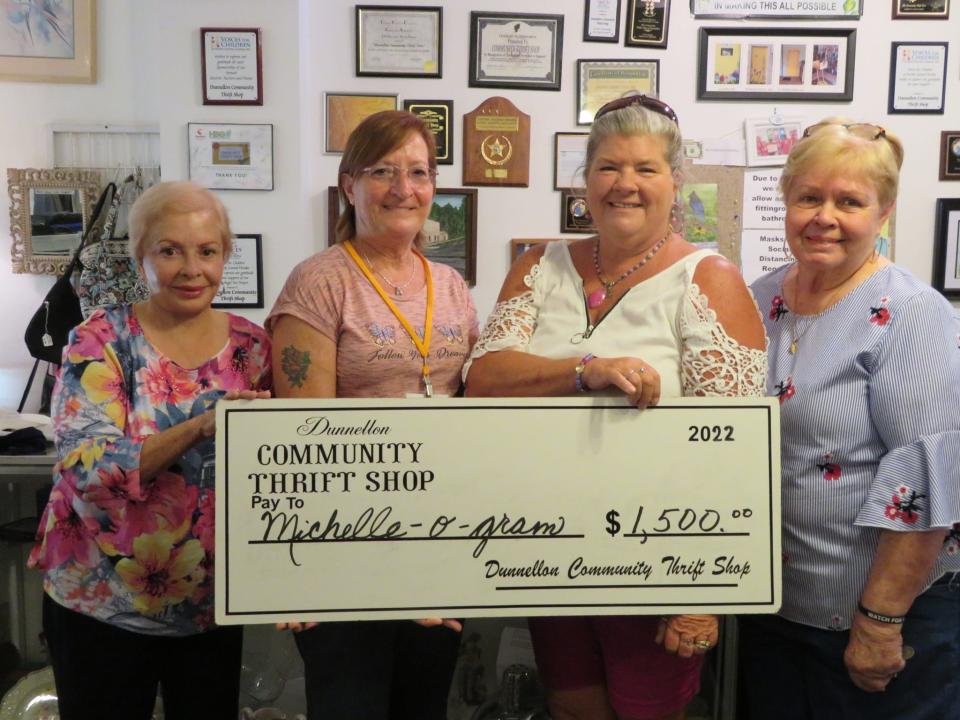 From left: Thrift Shop volunteers Betty Tilley-Poole and Jody Boyd present a $1,500 check to Michelle-O-Gram representatives Stacy Carroll and Sherry Roberts.