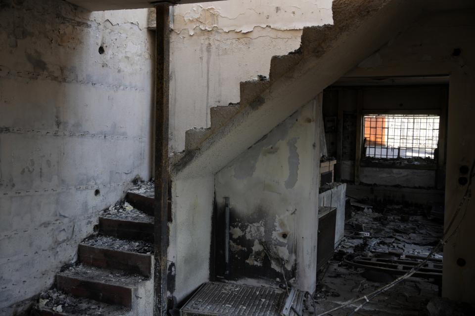 The interior of a burnt house in Acharnes suburb, on Mount Parnitha, in northwestern Athens, Greece, Thursday, Aug. 24, 2023. A major wildfire burning on the northwestern fringes of the Greek capital has torched homes and is now threatening the heart of a national park of Parnitha, one of the last green areas near the Greek capital. (AP Photo/Thanassis Stavrakis)