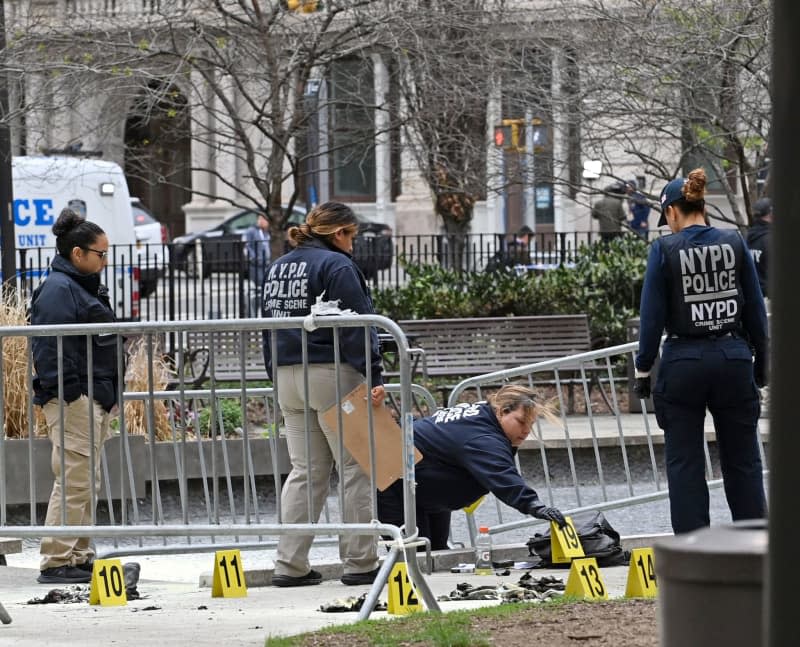 Members of New York City Fire Department (FDNY) inspect the scene in the aftermath of a man setting himself on fire, in the park across from the NYS Criminal Courthouse. According to US media reports, a man set himself on fire in a park opposite the courthouse in New York during the ongoing criminal trial of former president Donald Trump. Andrea Renault/ZUMA Press Wire/dpa