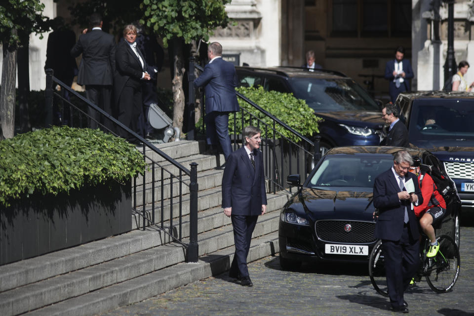 Members of Parliament, including Leader of the House of Commons Jacob Rees-Mogg, queue outside the House of Commons in Westminster, London, as they wait to vote on the future of proceedings, amid a row over how Commons business can take place safely.