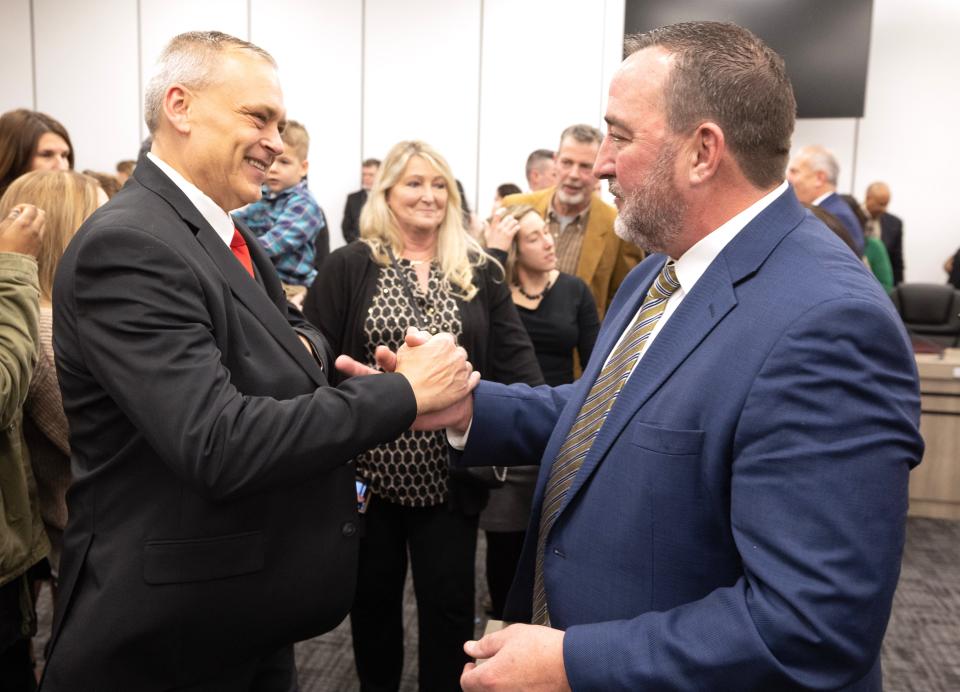 Democrat William Sherer II, right, is congratulated by his former opponent, Republican Roy Scott DePew. Sherer was took his oath of office Thursday as Canton's mayor.