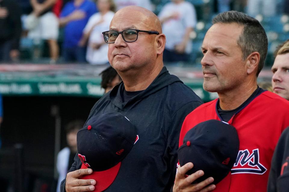 Cleveland Guardians manager Terry Francona, left, stands for the national anthem next to third base coach Mike Sarbaugh, right, before the team's baseball game against the Los Angeles Dodgers, Tuesday, Aug. 22, 2023, in Cleveland. (AP Photo/Sue Ogrocki)