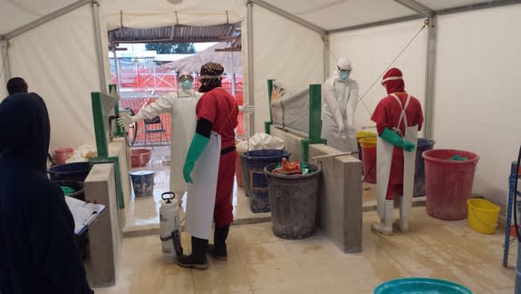 Health care workers prepare to treat patients with Ebola virus at a treatment center in West Africa.