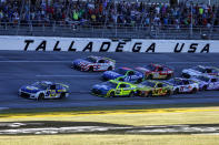 Chase Elliott (9) leads the field to the finish line during a NASCAR Cup Series auto race Sunday, Oct. 2, 2022, in Talladega, Ala. (AP Photo/Butch Dill)