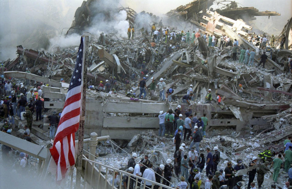 A US flag flies above the twisted steels of the World Trade Centre. (Caters)