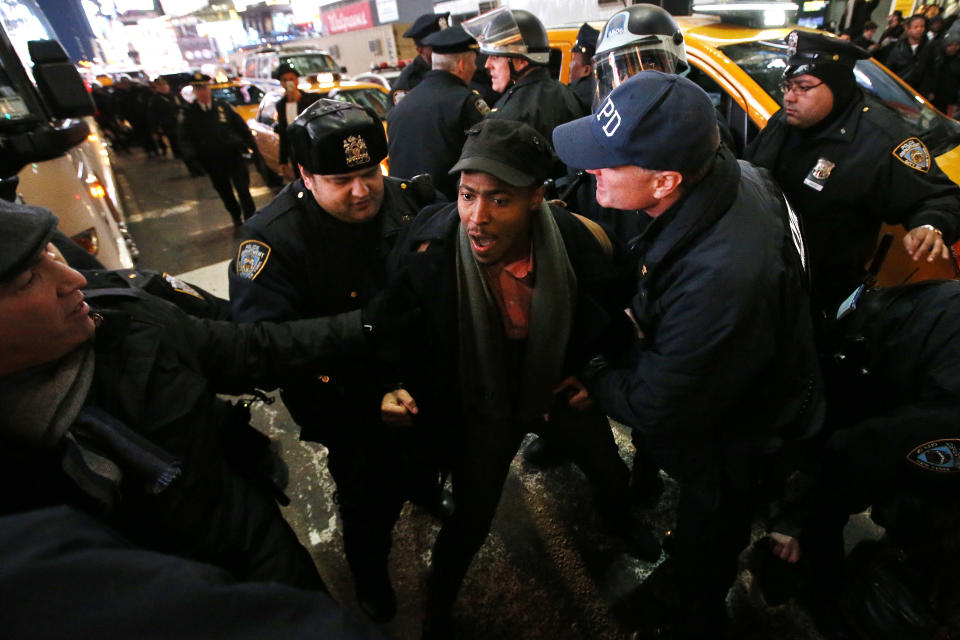 Police make arrests after protesters rallying against a grand jury's decision not to indict the police officer involved in the death of Eric Garner attempted to block traffic at the intersection of 42nd Street and Seventh Avenue near Times Square, Thursday, Dec. 4, 2014, in New York. (AP Photo/Jason DeCrow)