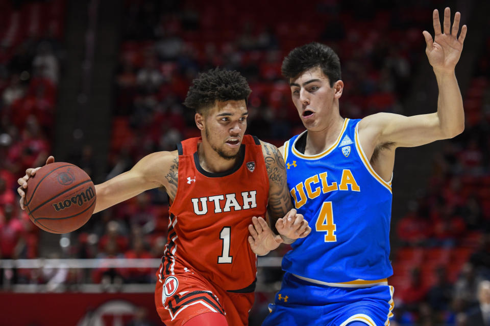 Utah forward Timmy Allen (1) drives as UCLA guard Jaime Jaquez Jr. (4) defends during the second half of an NCAA college basketball game Thursday, Feb. 20, 2020, in Salt Lake City. (AP Photo/Alex Goodlett)