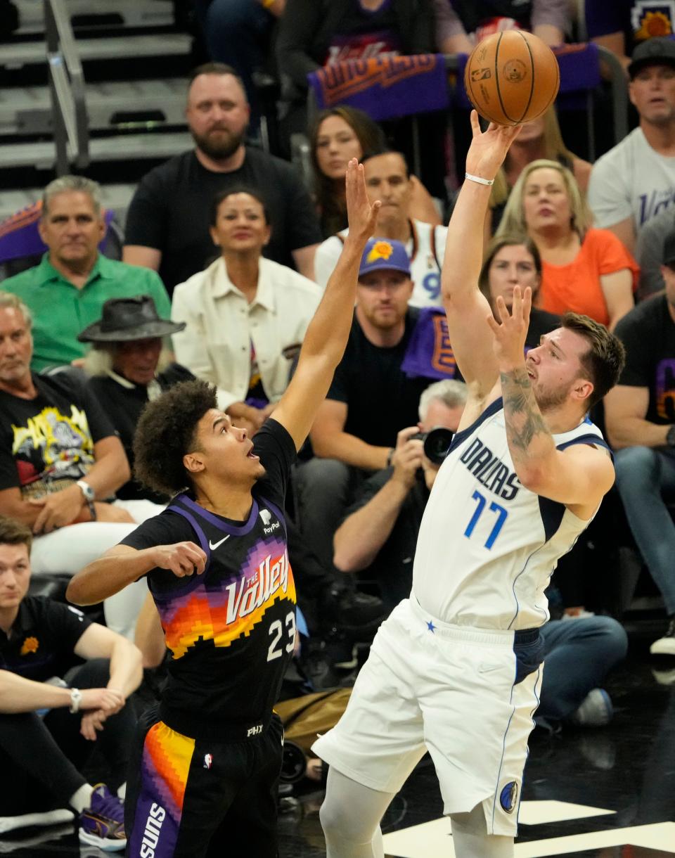 May 2, 2022; Phoenix, Arizona, USA; Phoenix Suns forward Cameron Johnson (23) defends against Dallas Mavericks guard Luka Doncic (77) during game one of the NBA Western Conference semifinals at Footprint Center.