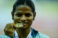 <p>Dutee Chand of Odisha poses with her winning medal after victory in the 100 metre race during 20th Federation Cup National Senior Athletics Championship in New Delhi on April 28, 2016. </p>