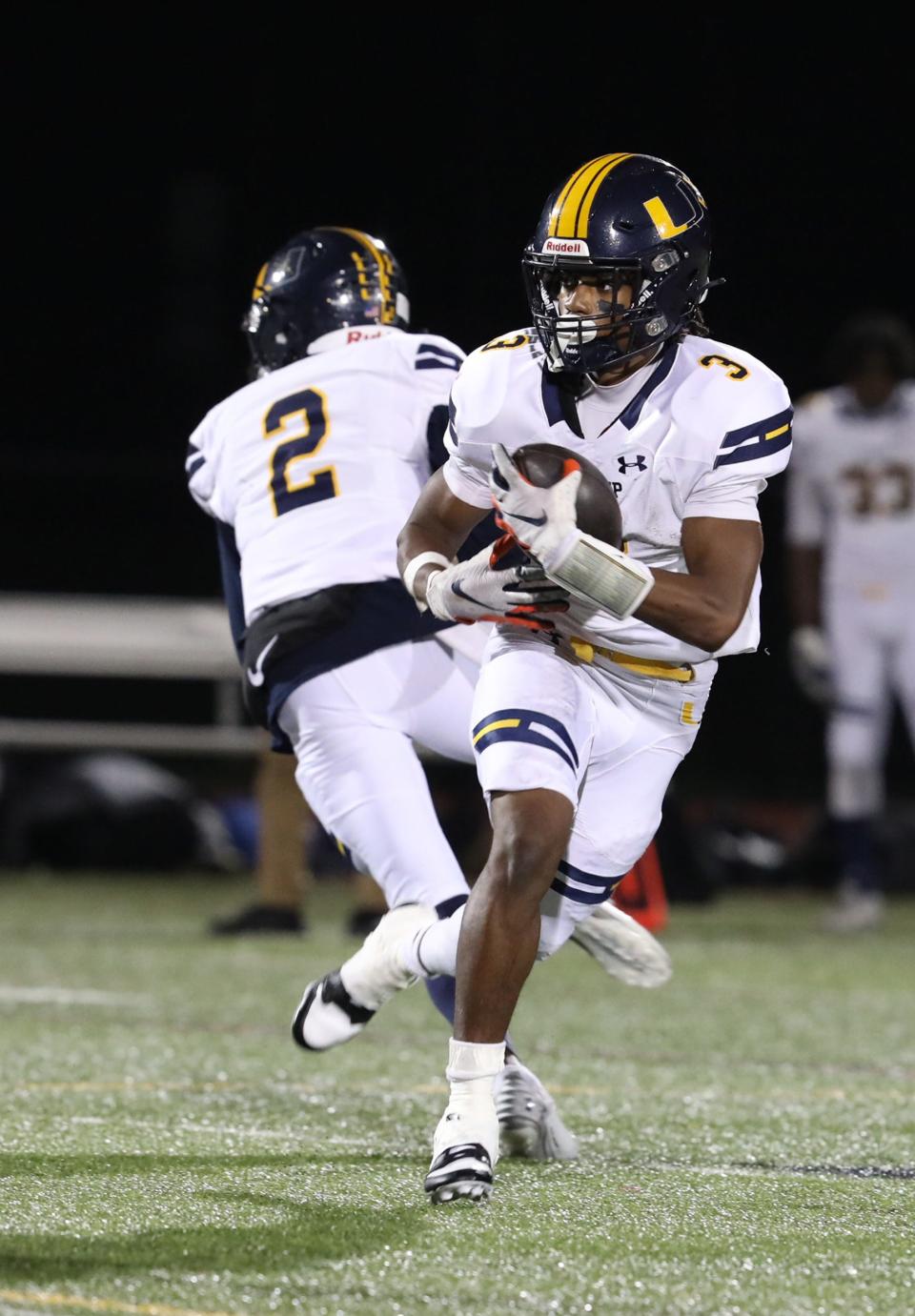 UPrep's C.J. Robinson Jr. gets the hand off and looks for an opening to run through.