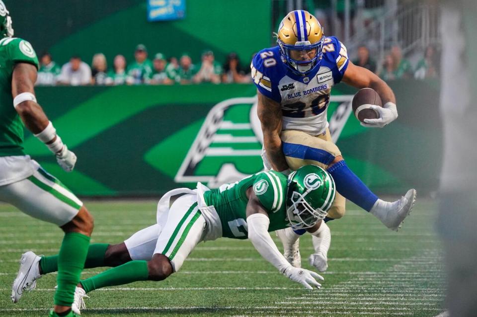 Winnipeg Blue Bombers running back Brady Oliveira (20) is tackled by Saskatchewan Roughriders running back Frankie Hickson (20) during the second half of CFL Labour Day Classic football action in Regina on Sunday.