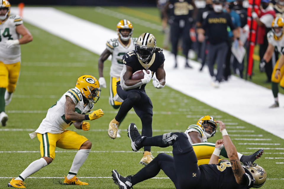 New Orleans Saints running back Alvin Kamara (41) leaps as he carries on a 52 yard touchdown pass play in the second half of an NFL football game against the Green Bay Packers in New Orleans, Sunday, Sept. 27, 2020. (AP Photo/Brett Duke)