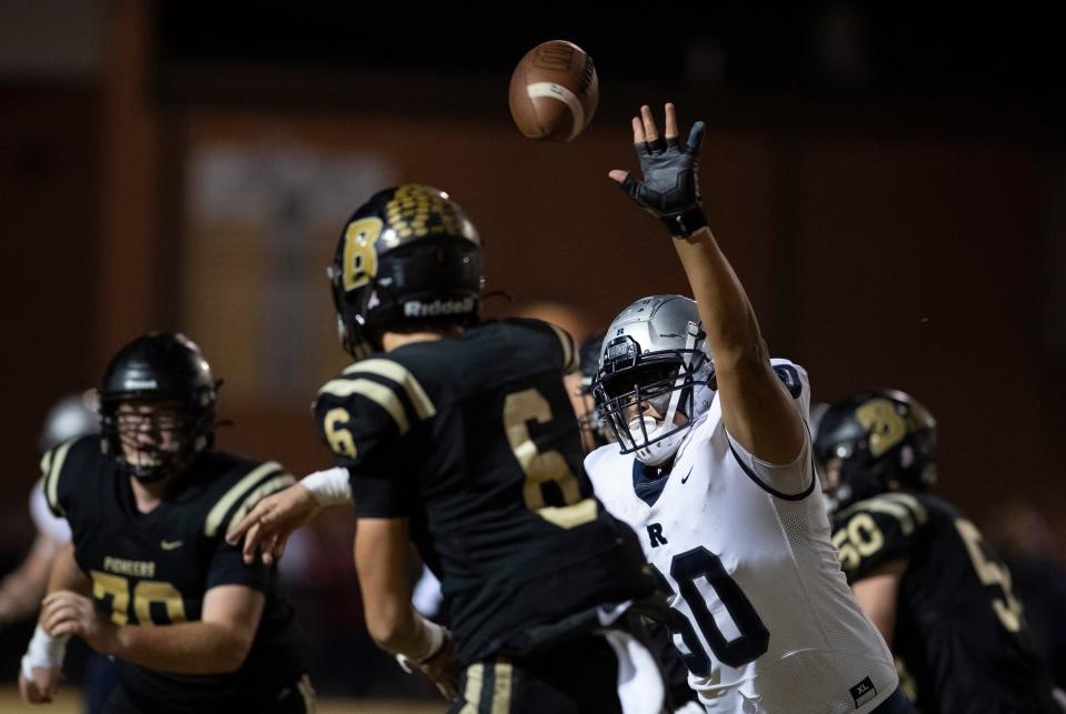 Reitz's Harlen Summers (60) pressures Boonville’s Clay Conner (6) during their IHSAA sectional semifinal at Bennett Field in Boonville, Ind., Friday night, Oct. 28, 2022. The Pioneers upset the 10-0 Panthers 28-27 to advance to next week's sectional championship game.