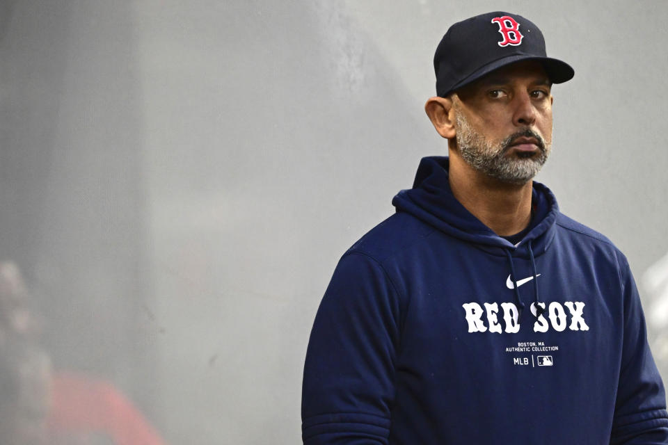 Boston Red Sox manager Alex Cora stands in the dugout in the fifth inning of a baseball game against the Cleveland Guardians, Tuesday, April 23, 2024, in Cleveland. (AP Photo/David Dermer)