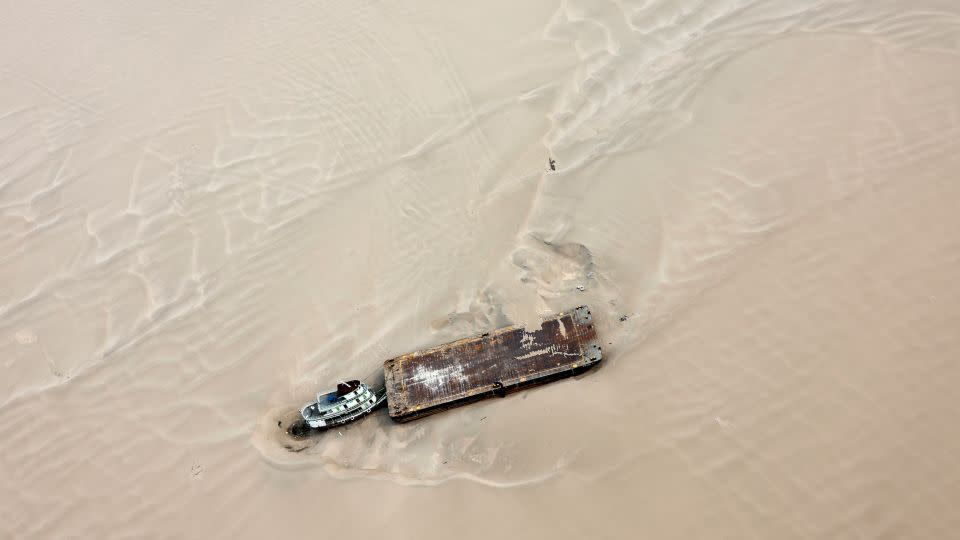 A hopper barge stranded on a sandbank at the Solimões River, near Tefé, Amazonas state, Brazil on September 17, 2024. - Jorge Silva/Reuters