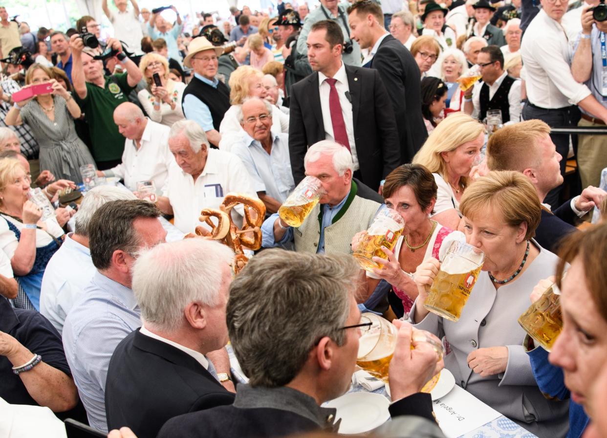 Angela Merkel joins drinkers in a beer tent in Munich on Sunday. The German Chancellor has warned that Europe can no longer rely on the US and UK in the manner it has since 1945: Getty