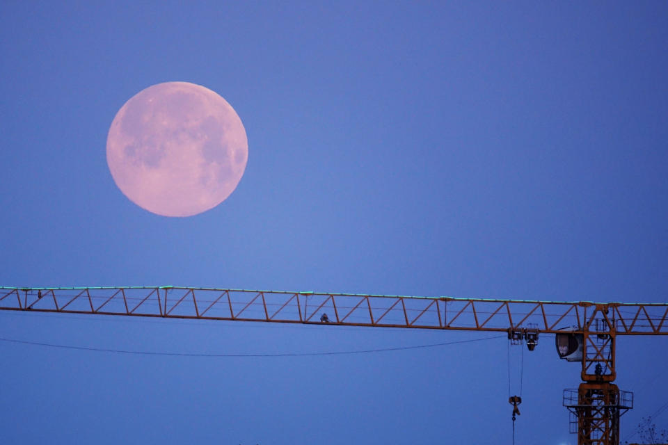 DALIAN, CHINA - APRIL 08: A supermoon rises over a crane on April 8, 2020 in Dalian, Liaoning Province of China. (Photo by Liu Debin/VCG via Getty Images)