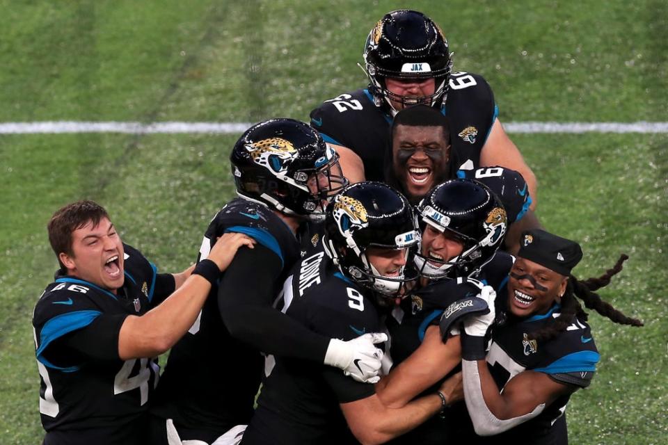 Matthew Wright is mobbed by team-mates after his field goal seals a dramatic win (Tottenham Hotspur FC via Getty I)