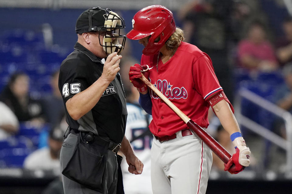 Philadelphia Phillies' Alec Bohm, right, talks with home plate umpire Jeff Nelson after he was called out on strikes during the fourth inning of the team's baseball game against the Miami Marlins, Thursday, Sept. 15, 2022, in Miami. (AP Photo/Lynne Sladky)